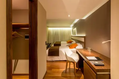 a hotel room with a bed and a desk and a desk at Yrigoyen 111 Hotel in Cordoba