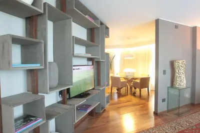 a living room with a large entertainment center with a television at Yrigoyen 111 Hotel in Cordoba