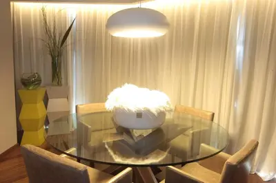 a dining room with a glass table and chairs at Yrigoyen 111 Hotel in Cordoba