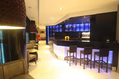 a bar in a restaurant with bar stools at Yrigoyen 111 Hotel in Cordoba