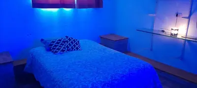 a blue room with a bed with a blue bed sidx sidx sidx at Dpto del Sur in San Roque