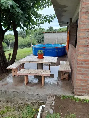 a picnic table in a backyard with a pool at Dpto del Sur in San Roque