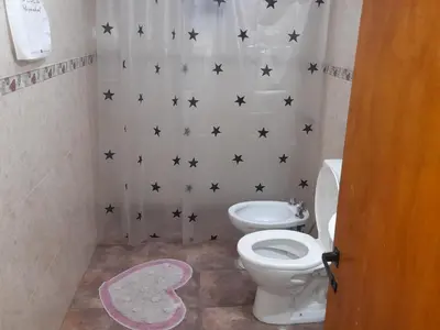 a bathroom with a toilet and black stars on the wall at Dpto del Sur in San Roque