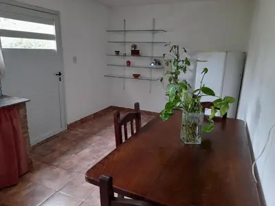 a wooden table in a kitchen with a vase on it at Dpto del Sur in San Roque