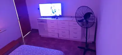 a room with a fan in front of a dresser at Dpto del Sur in San Roque