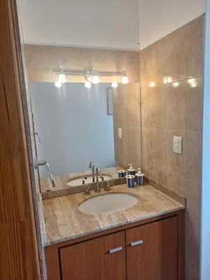a bathroom with a sink and a mirror at Casa Frente Dique Piedras Moras in Almafuerte