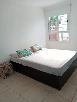 a bed sitting in a room with a window at Habitación Colon in Cordoba