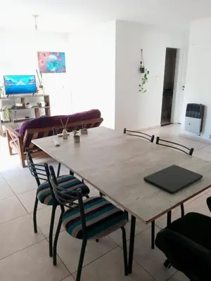 a wooden table and chairs in a room at Habitación Colon in Cordoba