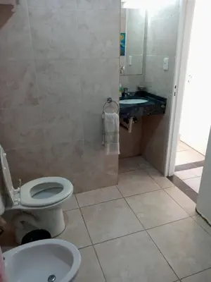 a bathroom with a toilet and a sink at Habitación Colon in Cordoba