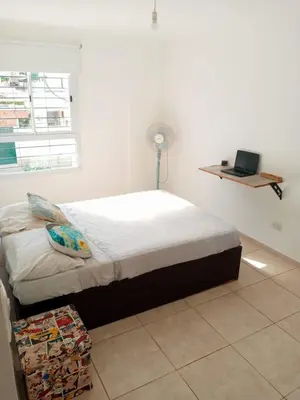 a bedroom with a bed with a laptop on the wall at Habitación Colon in Cordoba