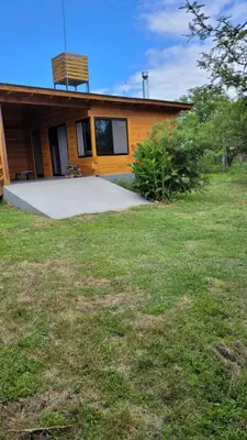 a house with a lawn in front of it at Sueño Serrano in Santa Rosa de Calamuchita