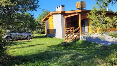a house with a car parked in front of it at Sueño Serrano in Santa Rosa de Calamuchita