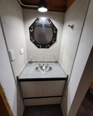 a bathroom with a sink with a mirror on the wall at Sueño Serrano in Santa Rosa de Calamuchita