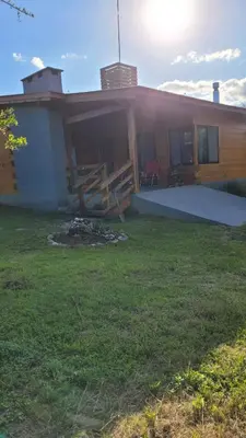 a house with a picnic table in front of it at Sueño Serrano in Santa Rosa de Calamuchita