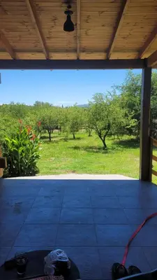 an open porch with a view of a field of trees at Sueño Serrano in Santa Rosa de Calamuchita
