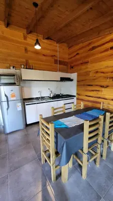 a kitchen with a table and chairs in a room at Sueño Serrano in Santa Rosa de Calamuchita