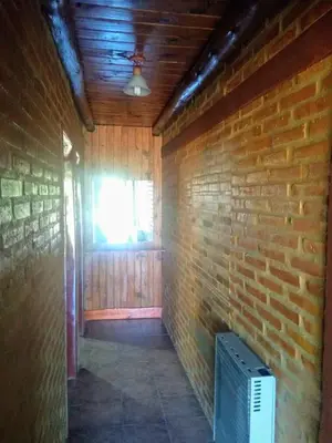 a room with a brick wall and a window at Apart & Cabañas 