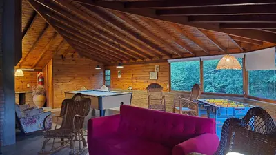 a living room with a purple couch and chairs at Hosteria Rural Piedra y Camino in Nono