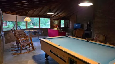 a living room with a pool table in it at Hosteria Rural Piedra y Camino in Nono