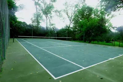 a tennis court with a net on it at Hosteria Rural Piedra y Camino in Nono