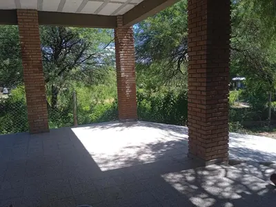 an open patio with brick columns and trees at Piquillin San Lorenzo in San Lorenzo