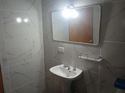 a bathroom with a sink and a mirror at Piquillin San Lorenzo in San Lorenzo
