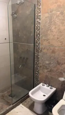a bathroom with a shower and a toilet and a sink at Hotel Rincon Del Este in General Deheza