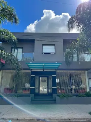 a blue house with a blue door and a fence at Hotel Rincon Del Este in General Deheza