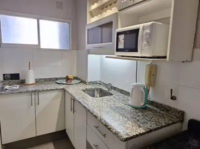 a small kitchen with a sink and a microwave at La mejor ubicación turística del centro Córdoba in Cordoba