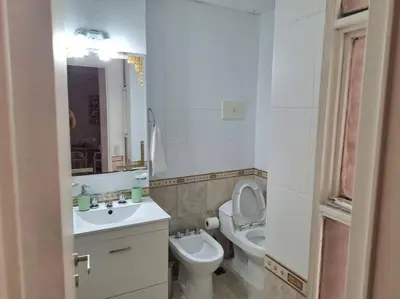 a white bathroom with a toilet and a sink at La mejor ubicación turística del centro Córdoba in Cordoba