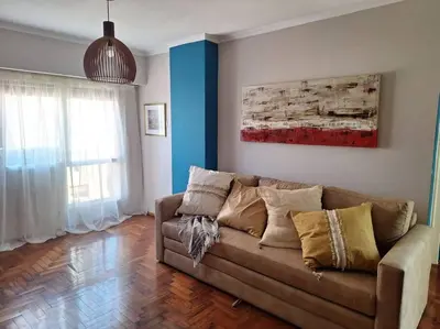 a living room with a couch and a painting on the wall at La mejor ubicación turística del centro Córdoba in Cordoba