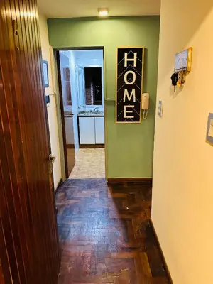 a hallway with a door leading to a kitchen at Refugio Urbano in Cordoba