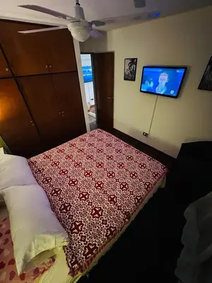 a bedroom with a bed with a red blanket on it at Refugio Urbano in Cordoba