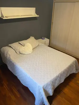 a bedroom with a bed with a white bedspread and a window at Departamento -Balcarce- Nueva Córdoba, ByApartcba in Cordoba