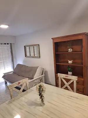 a living room with a table and a couch at Departamento -Balcarce- Nueva Córdoba, ByApartcba in Cordoba
