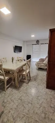 a living room with a table and a couch at Departamento -Balcarce- Nueva Córdoba, ByApartcba in Cordoba