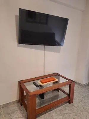 a coffee table with a television on a wall at Departamento -Balcarce- Nueva Córdoba, ByApartcba in Cordoba