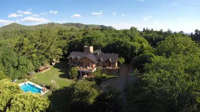an aerial view of a house in the woods at Posada La Escondida in Villa General Belgrano