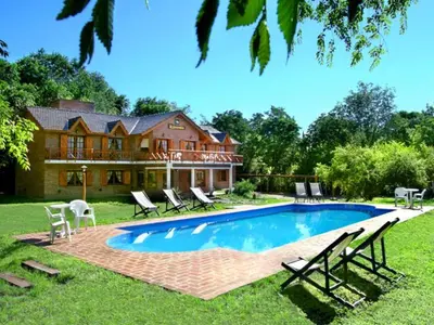 a house with a swimming pool in the yard at Posada La Escondida in Villa General Belgrano