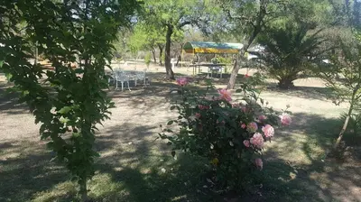 a garden with a table and chairs and flowers at White Field Houses and Spa in Villa de Las Rosas
