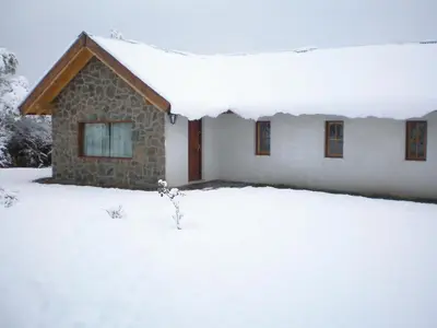 a house is covered in snow at White Field Houses and Spa in Villa de Las Rosas
