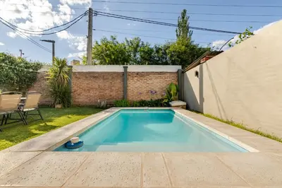 a swimming pool in the backyard of a house at Familia y Amigos con Pileta, Asador y Cochera in Cordoba