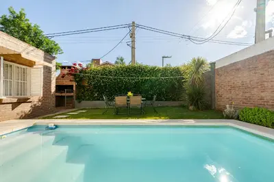 a swimming pool in the backyard of a house at Familia y Amigos con Pileta, Asador y Cochera in Cordoba