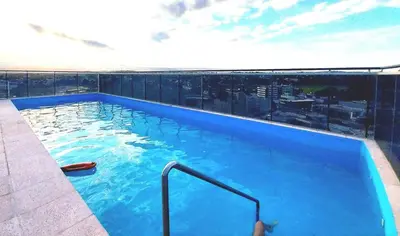 a large blue swimming pool on top of a building at Depto Etoile 2 ubicación confort y amenities in Villa Carlos Paz
