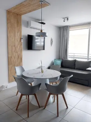 a living room with a table and chairs and a couch at Depto Etoile 2 ubicación confort y amenities in Villa Carlos Paz