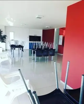 a waiting area with chairs and a piano in a room at Depto Etoile 2 ubicación confort y amenities in Villa Carlos Paz