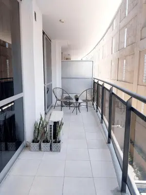 a balcony with two chairs and a chalkboard on a building at Depto Etoile 2 ubicación confort y amenities in Villa Carlos Paz