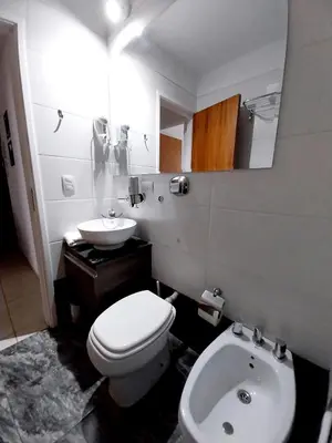 a bathroom with a white toilet and a sink at Depto Etoile 2 ubicación confort y amenities in Villa Carlos Paz