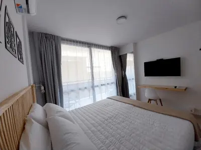 a bedroom with a large bed and a television at Depto Etoile 2 ubicación confort y amenities in Villa Carlos Paz