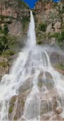 a waterfall on the side of a mountain at Mis Aromos in Mina Clavero